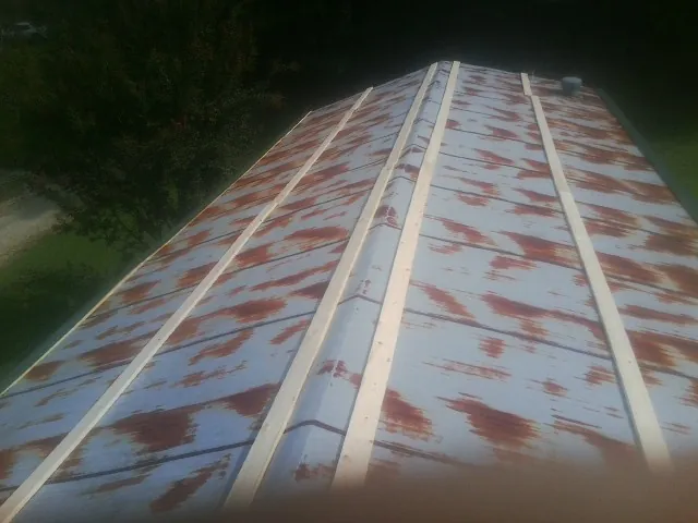 Rusted metal roof panels with new wood purlins before replacement — Storm Damage Roof Repair in Fulton by Roofing Brothers